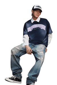 Model wearing MEDM SS25 Washed Arch Logo Tee paired with distressed jeans and cap