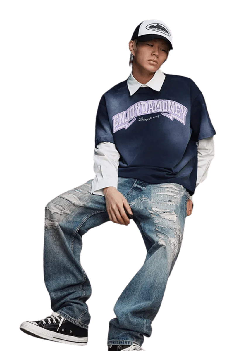 Model wearing MEDM SS25 Washed Arch Logo Tee paired with distressed jeans and cap
