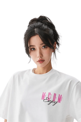 Model wearing a white MEDM Three Colour Print Tee with stylish logo design for casual fashion