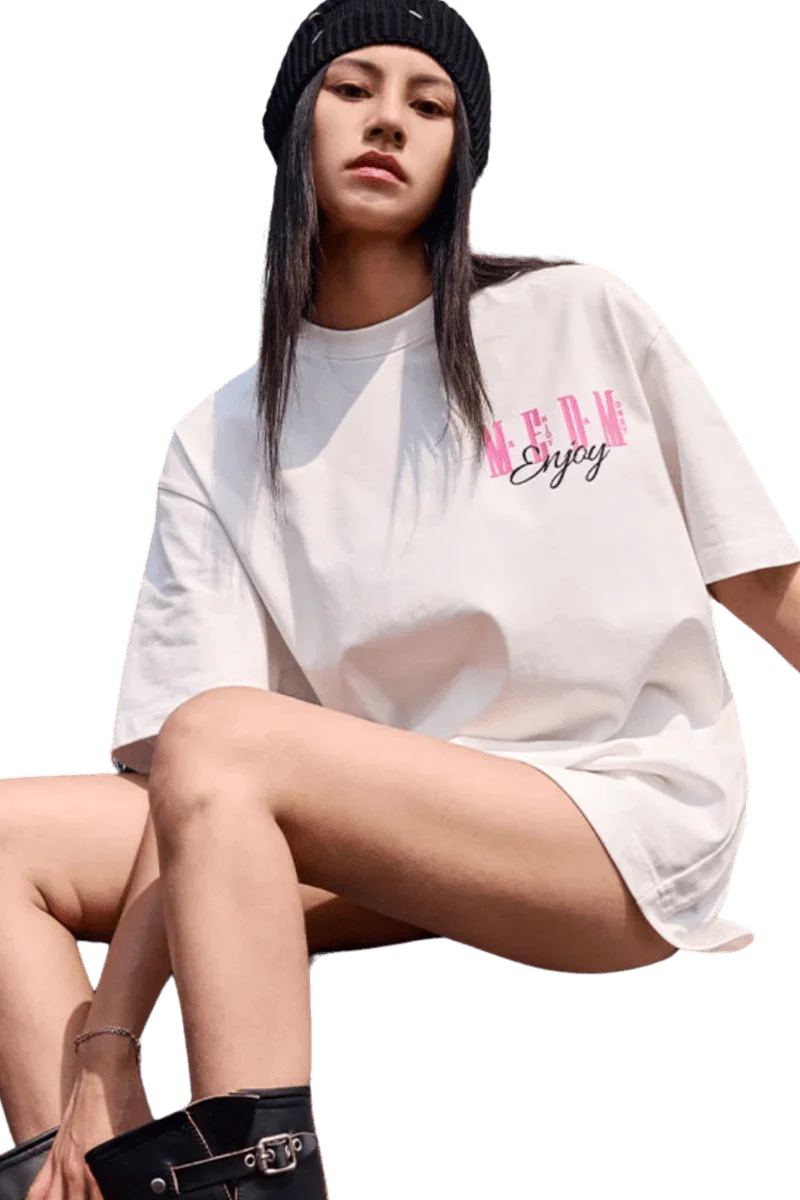 Model wearing a MEDM Three Colour Print Tee in white with stylish oversized fit and logo design