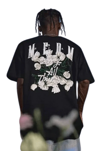 Back view of MEDM White Rose Embroidery Tee black shirt with white rose design worn by male model