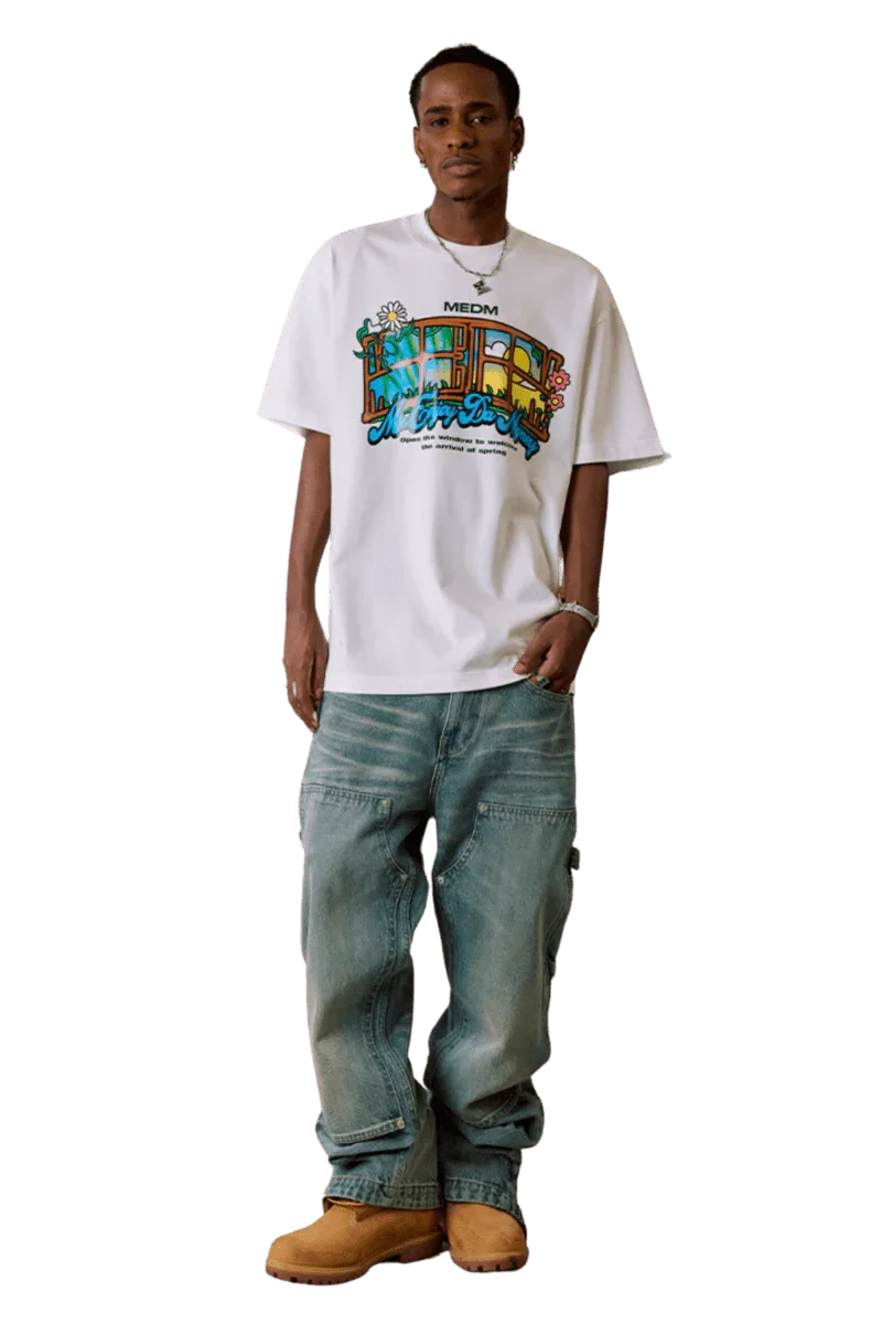 Model wearing white MEDM Window Spring Tee with colorful graphic and loose fit jeans