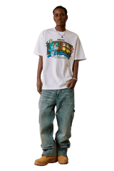 Model wearing white MEDM Window Spring Tee with colorful graphic and loose fit jeans