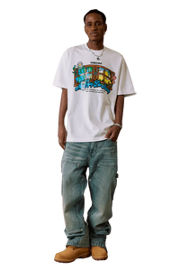 Model wearing white MEDM Window Spring Tee with colorful graphic and loose fit jeans