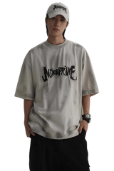 Masonprince Vintage Patch Tee in light gray with black logo print worn by model with cap and watch