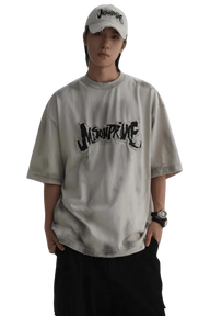 Masonprince Vintage Patch Tee in light gray with black logo print worn by model with cap and watch