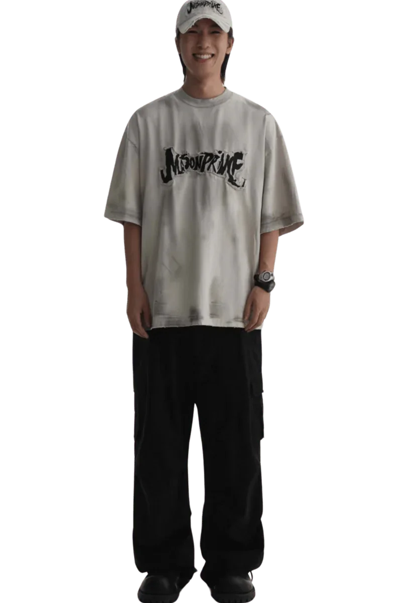 Masonprince Vintage Patch Tee worn by a smiling model with black pants and a white cap