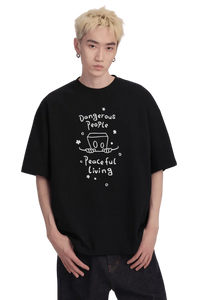 Dangerous People Peaceful Living Hand Painted Tee in black featuring a unique graphic design