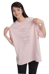 Model wearing Dangerous People Peaceful Living Hand Painted Tee in soft pink color