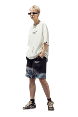 Trendy Dangerous People reflective wording t-shirt paired with stylish shorts for a modern streetwear look