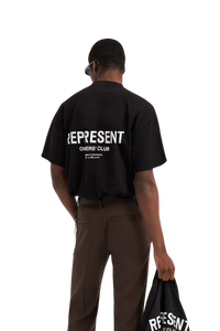 Man wearing Represent Owners Club T-Shirt in black with bold logo on back