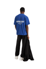Back view ofRepresent Owners Club T-Shirt in blue worn by a model with relaxed fit