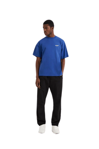 Men's blue Represent Owners Club T-Shirt styled with black pants for a casual look