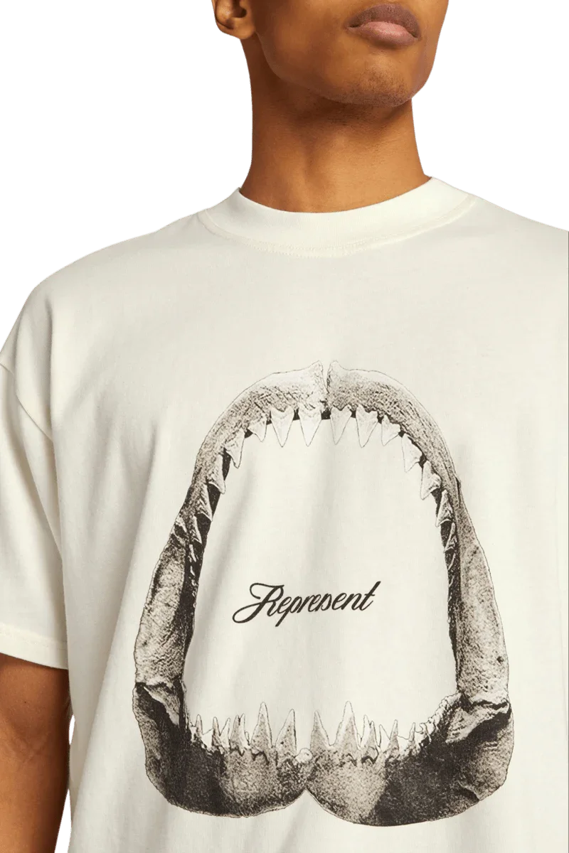 Represent Shark Jaws Tee featuring a graphic shark mouth design on a cream-colored shirt