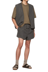 Fear Of God Essentials FW22 Flock Logo Tee displayed with matching shorts and vest for a stylish look