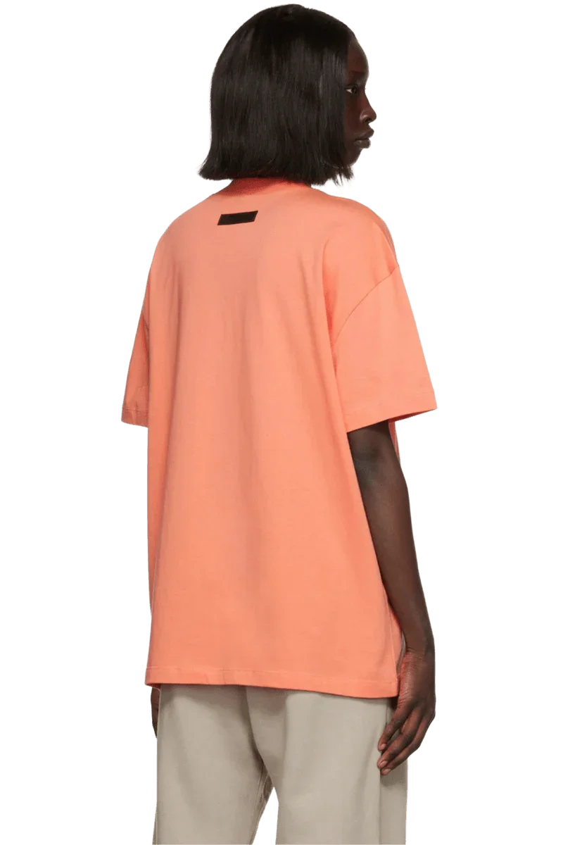 Fear Of God Essentials FW22 Flock Logo Tee in vibrant orange color with a relaxed fit