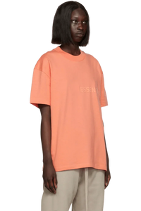 Fear Of God Essentials FW22 Flock Logo Tee in Peach Color with Relaxed Fit Design