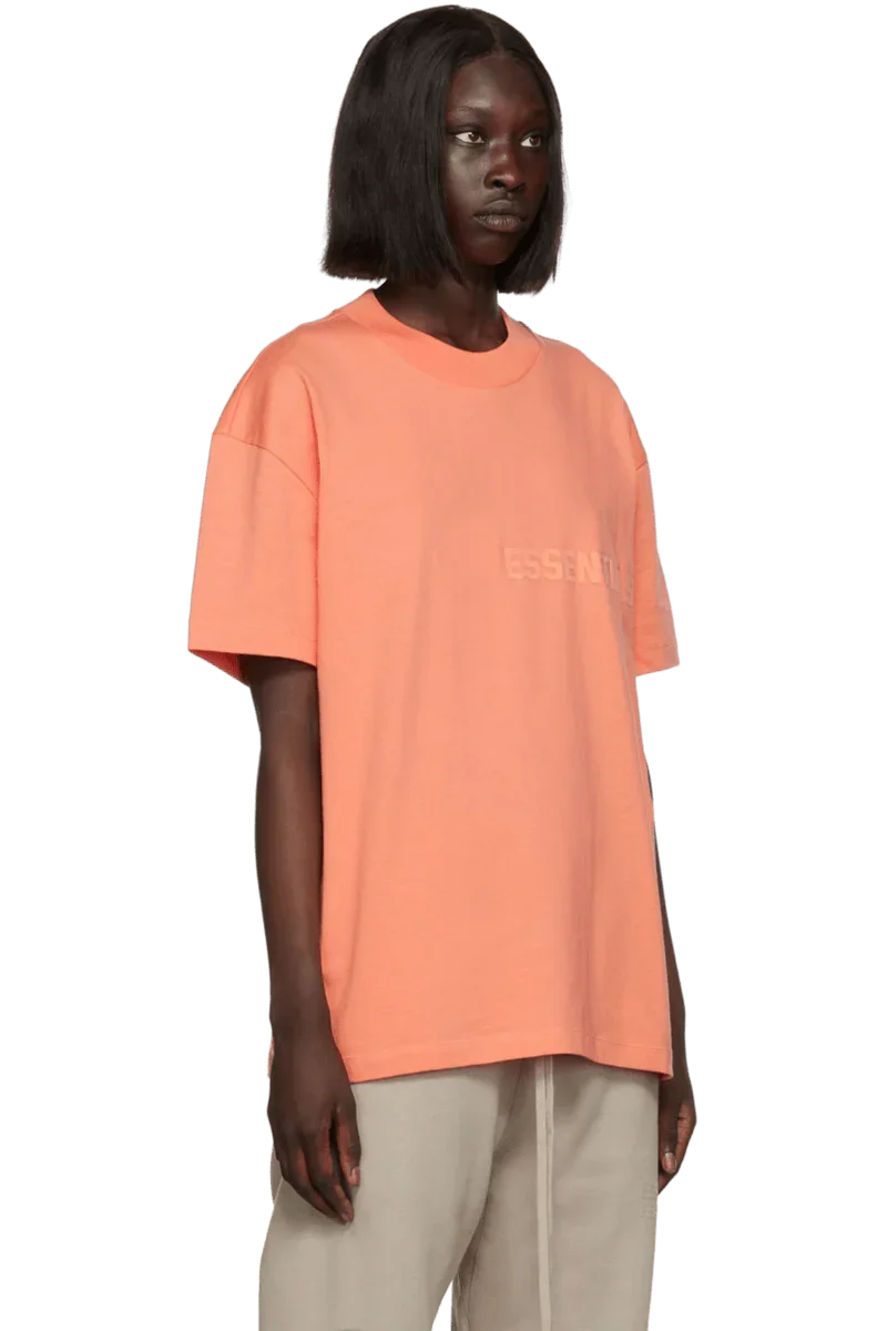 Fear Of God Essentials FW22 Flock Logo Tee in Peach Color with Relaxed Fit Design
