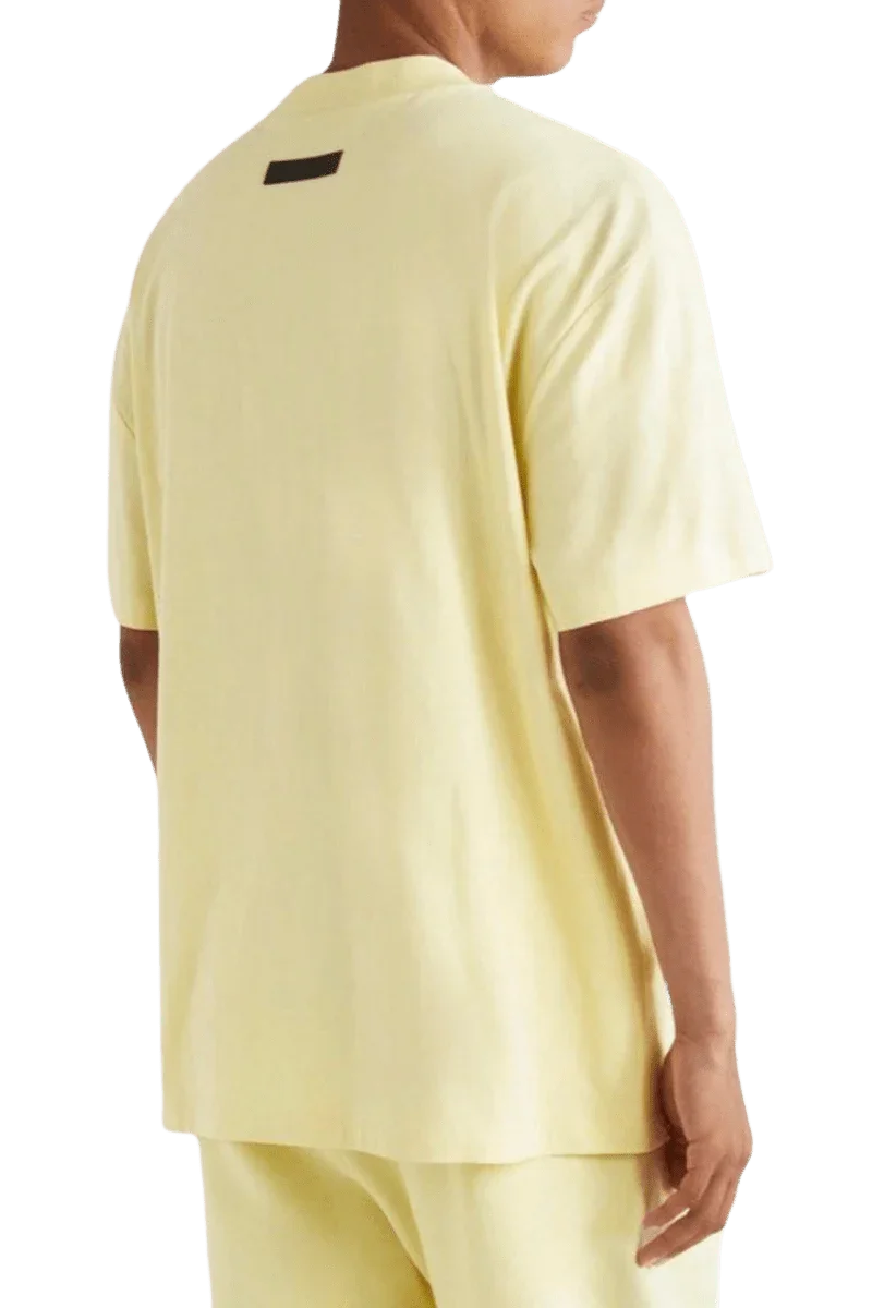 Fear Of God Essentials FW22 Flock Logo Tee in soft yellow with a relaxed fit and stylish back detail