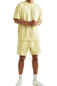 Fear Of God Essentials FW22 Flock Logo Tee in soft yellow with a relaxed fit for casual wear