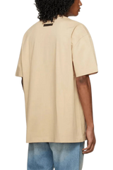 Fear Of God Essentials SS23 Rubber Embossed Tee in beige with a relaxed fit and short sleeves