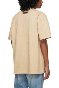 Fear Of God Essentials SS23 Rubber Embossed Tee in beige with a relaxed fit and short sleeves