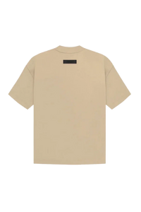 Fear Of God Essentials SS23 Rubber Embossed Tee in Beige with minimalist design on a black background