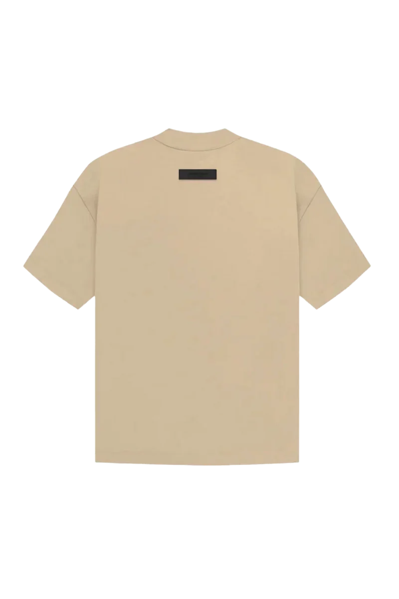 Fear Of God Essentials SS23 Rubber Embossed Tee in Beige with minimalist design on a black background