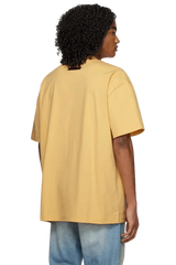Fear Of God Essentials SS23 Rubber Embossed Tee in Yellow with a relaxed fit and short sleeves
