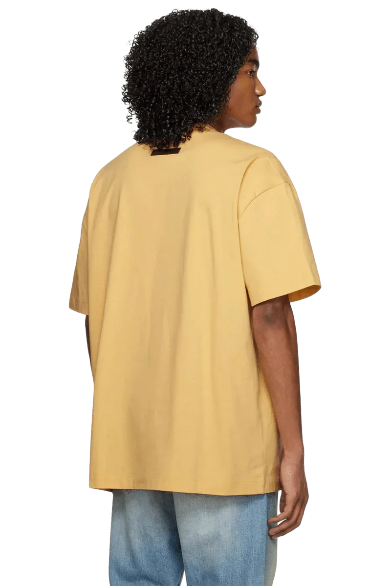 Fear Of God Essentials SS23 Rubber Embossed Tee in Yellow with a relaxed fit and short sleeves