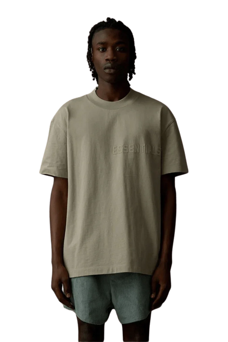 Fear Of God Essentials SS23 Rubber Embossed Tee in a neutral color worn by a model
